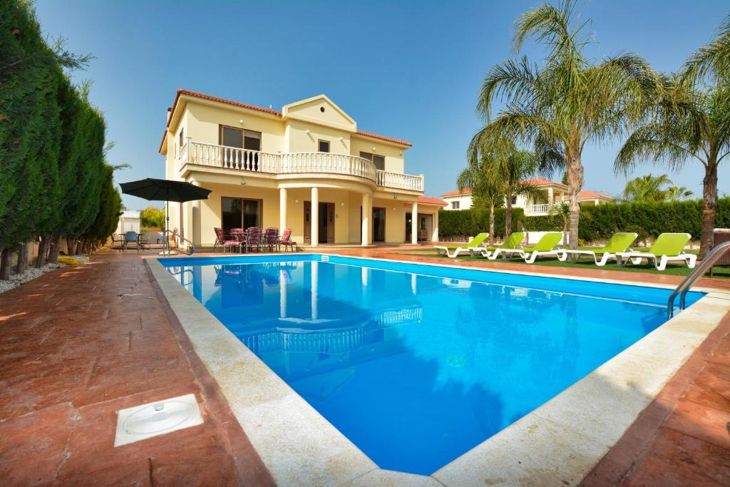 a swimming pool in front of a house at Villa Eva in Ayia Napa