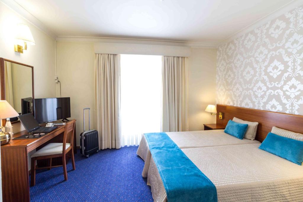 Uma cama ou camas num quarto em Hotel Eurosol Gouveia
