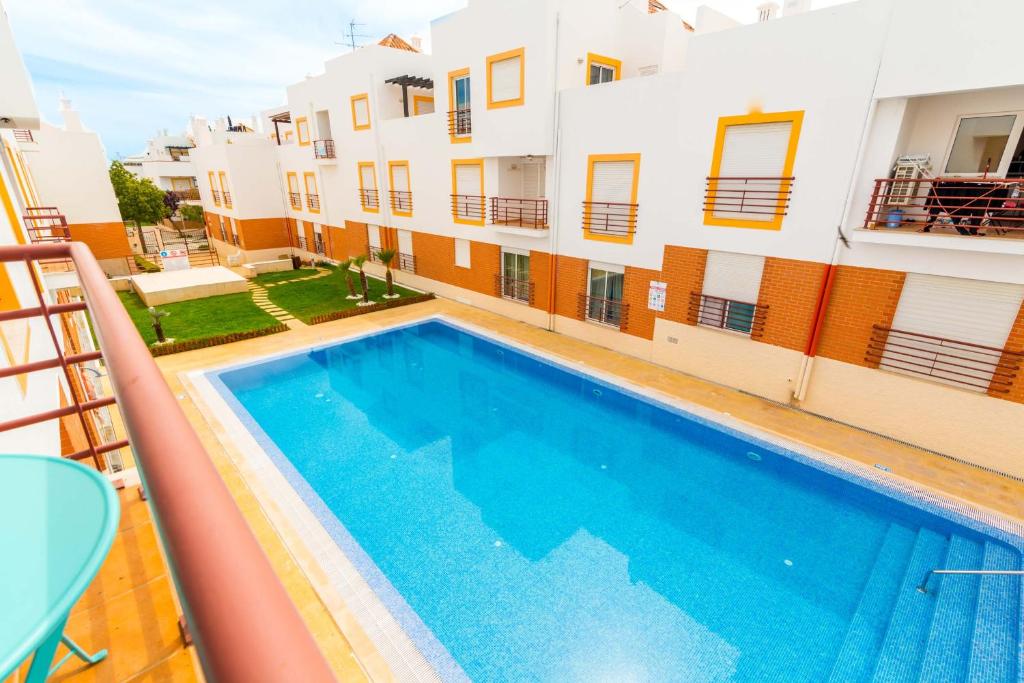 a swimming pool in front of a building at Quinta da Gomeira by Algartur in Cabanas de Tavira