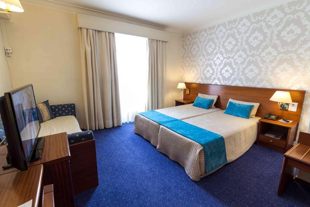 Uma cama ou camas num quarto em Hotel Eurosol Gouveia