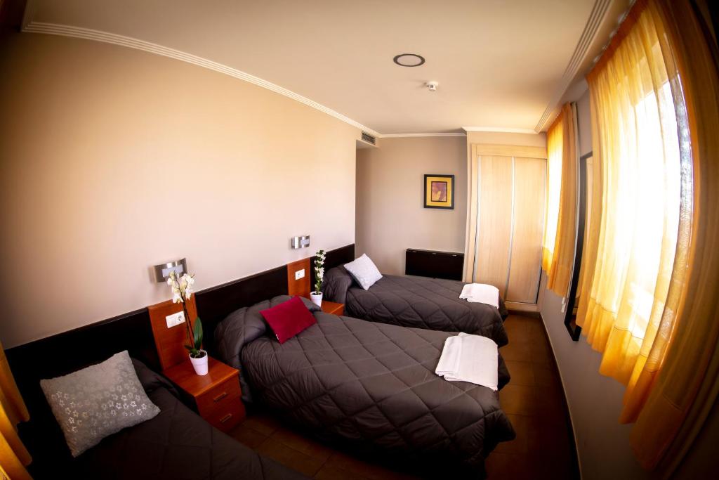Postel nebo postele na pokoji v ubytování Hostal Campestre
