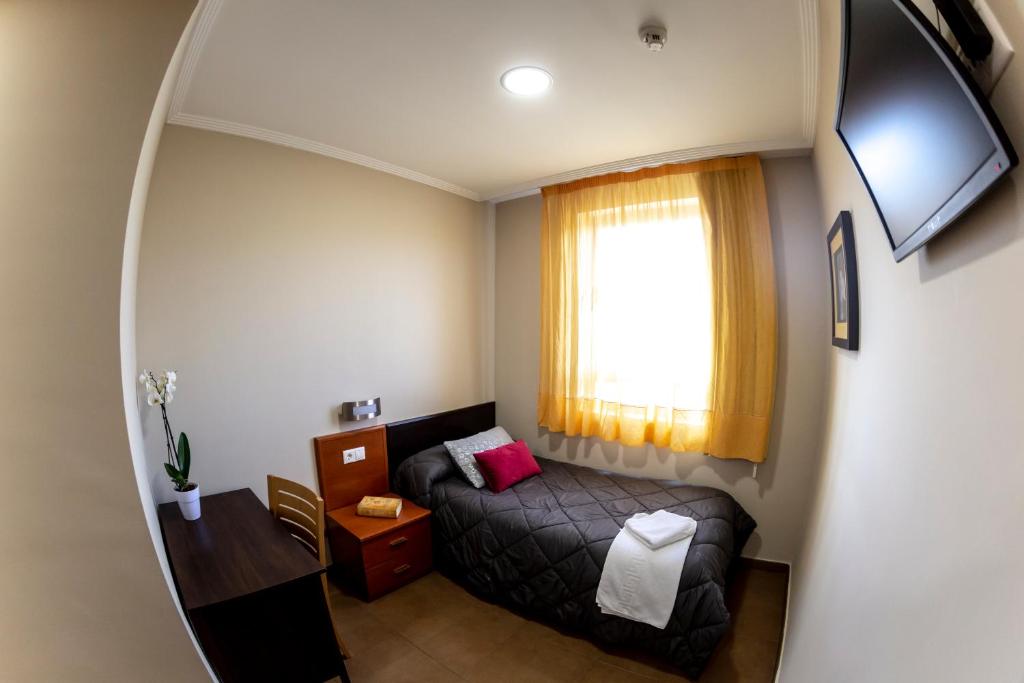 Postel nebo postele na pokoji v ubytování Hostal Campestre