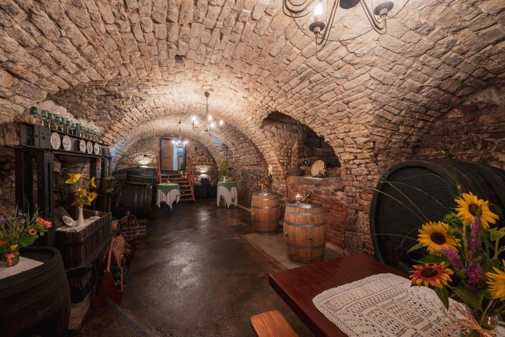 a wine cellar with barrels and flowers in a tunnel at Laubgassl in Mörbisch am See