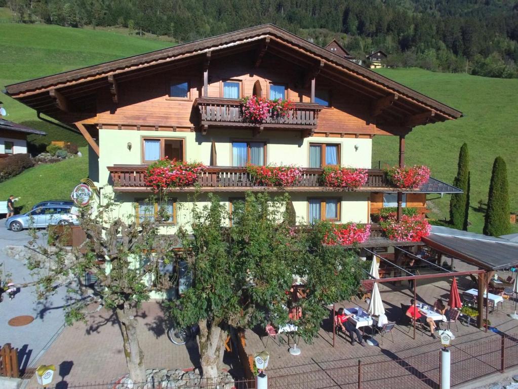 a large house with balconies and flowers on it at Appartements Sonnberg in Bad Hofgastein