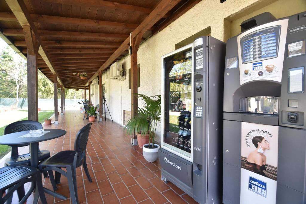 an outdoor patio with a drink cooler and a table at Villa Isabella in Marina di Grosseto