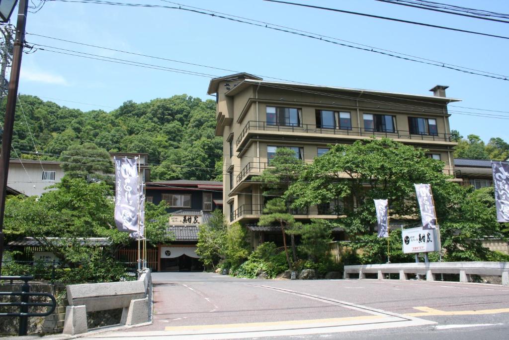 a building on a street with signs in front of it at Konya in Matsue