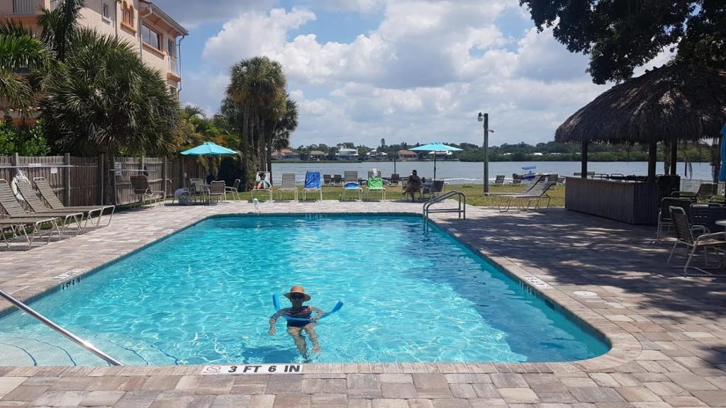a person in a swimming pool in a hotel at Siesta Key Condo - on the water ! in Siesta Key