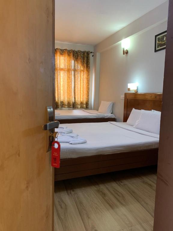 Postel nebo postele na pokoji v ubytování Hotel Jc Grand