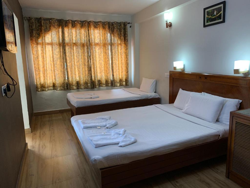 Postel nebo postele na pokoji v ubytování Hotel Jc Grand