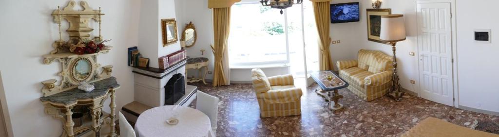 a living room with a couch and a fireplace at Appartamento in villa ad Ischia in Ischia
