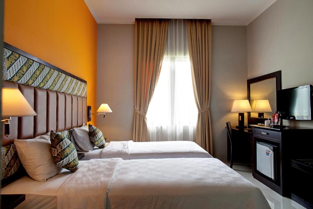 Postel nebo postele na pokoji v ubytování Le Dian Hotel