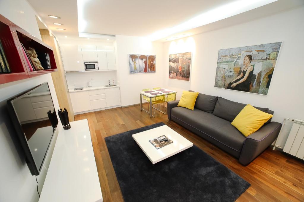 a living room with a couch and a tv at STATUS Superior Apartments in Belgrade