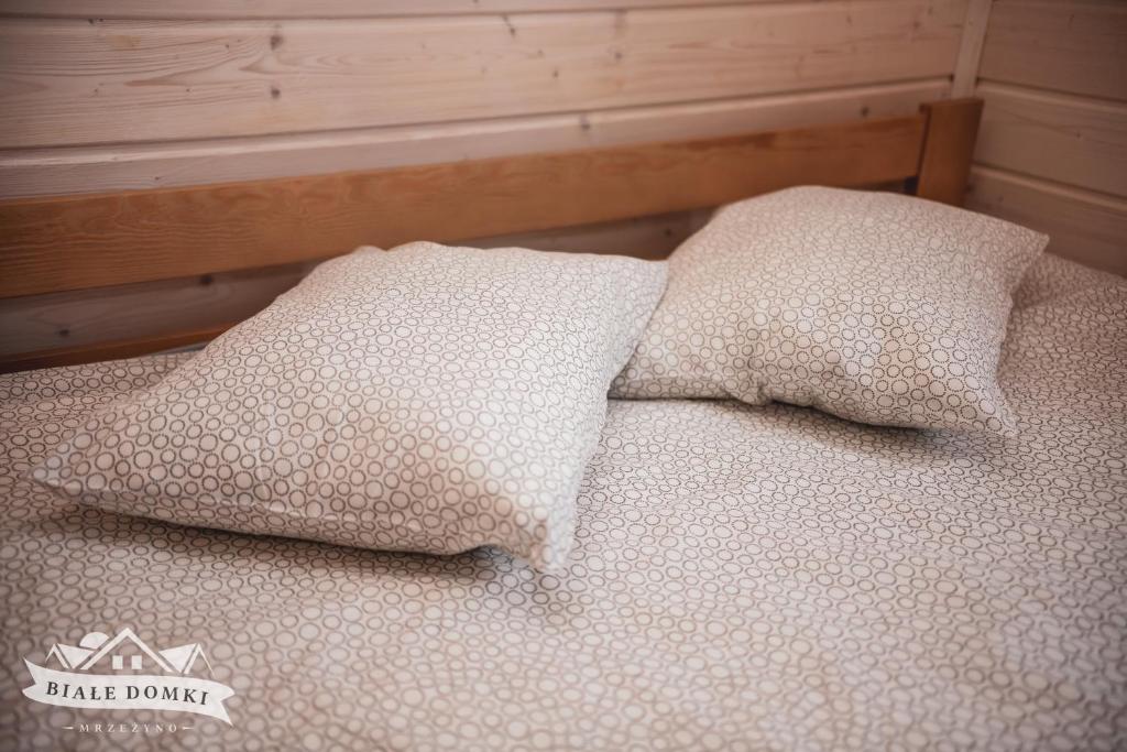 Postel nebo postele na pokoji v ubytování Białe Domki Mrzeżyno