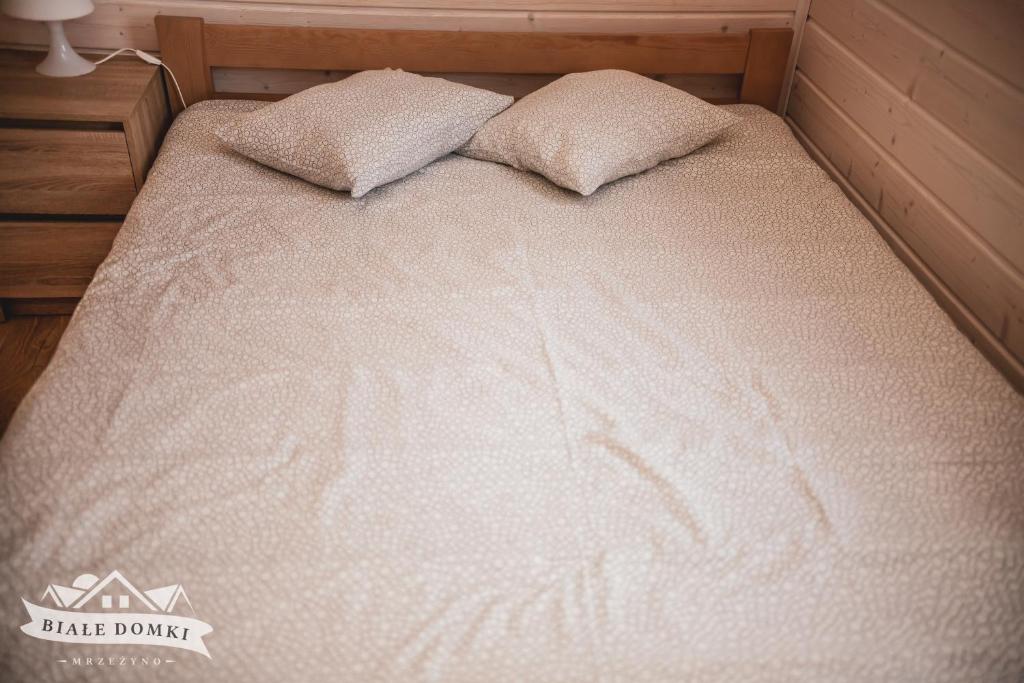 Postel nebo postele na pokoji v ubytování Białe Domki Mrzeżyno