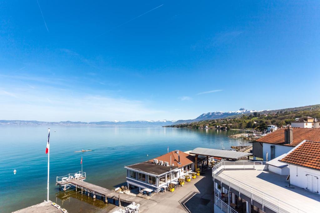 a view of a large body of water with a dock at Hôtel De La Plage in Amphion les Bains