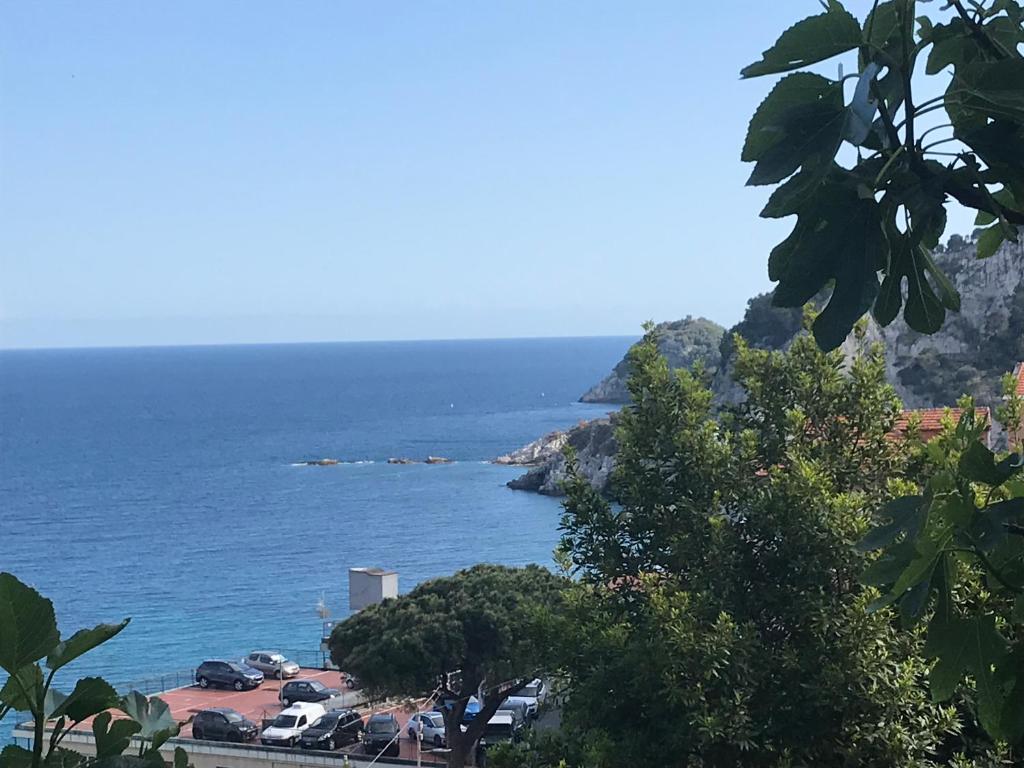 a view of the ocean with cars parked on a hill at Casa del sasso in Bergeggi