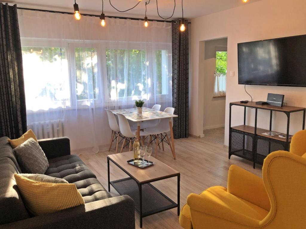 a living room with a couch and a table at Apartament Swoboda in Poznań