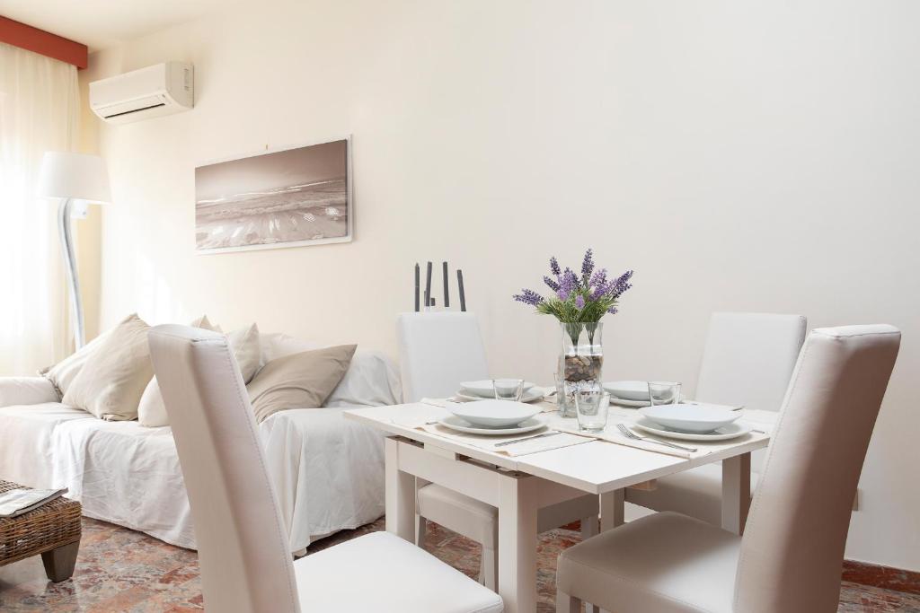 a white dining room with a white table and chairs at ANAGNINO WHITE HOME in Rome