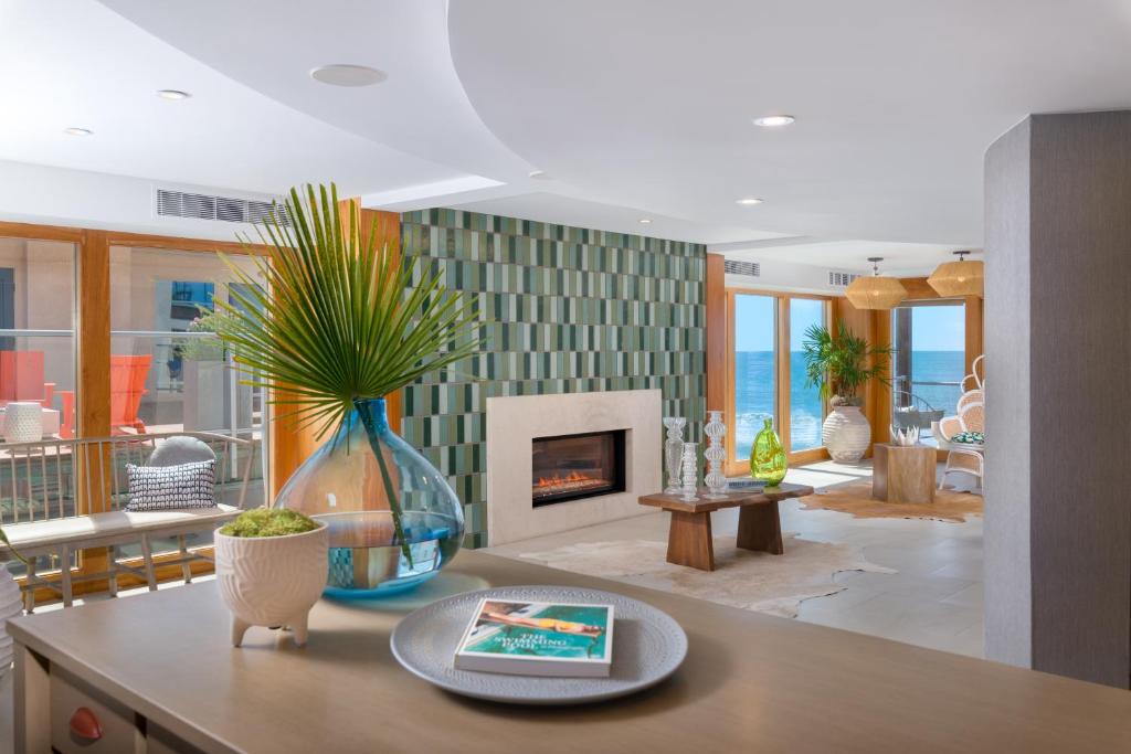 a living room with a table and a fireplace at Beach Terrace in Carlsbad