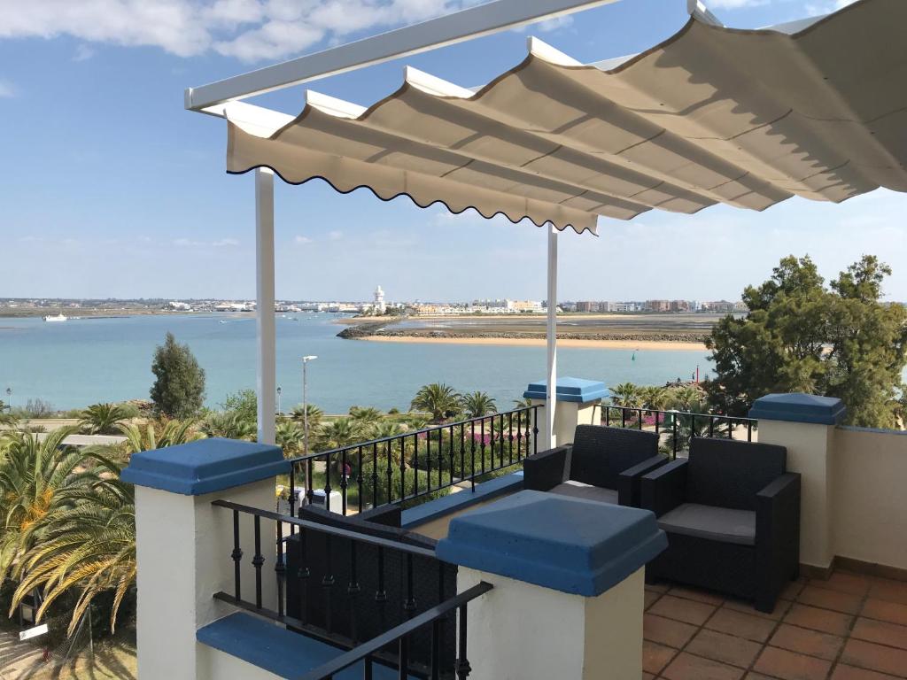 a balcony with a view of the water at Beautiful penthouse with ocean and marina views in Isla Canela