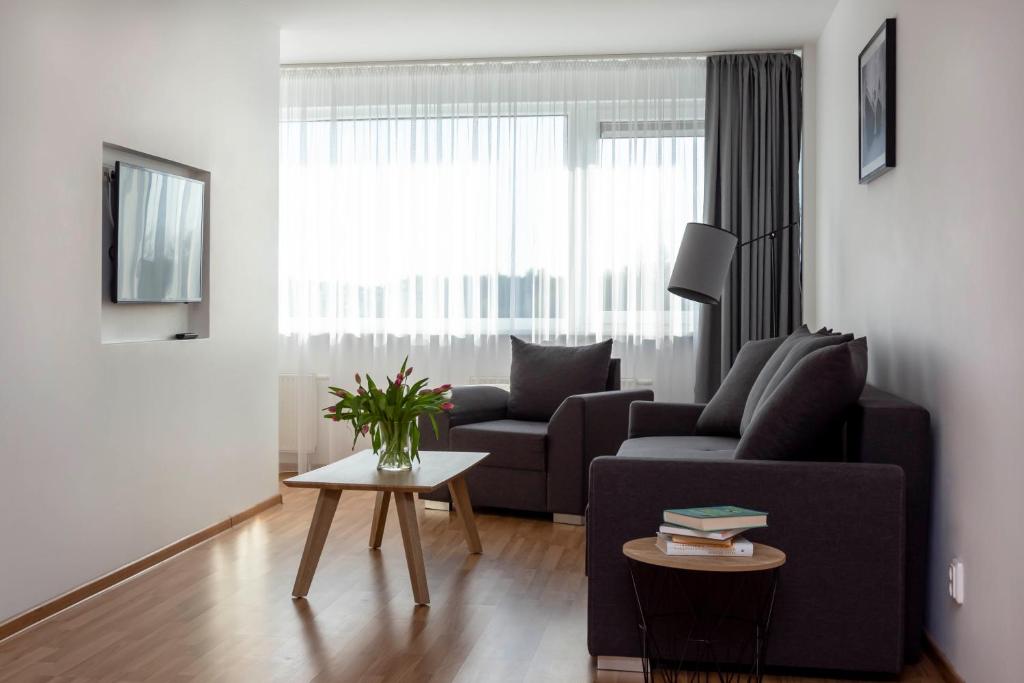 a living room with a couch and a table at Apartment Amber Wind in Palanga