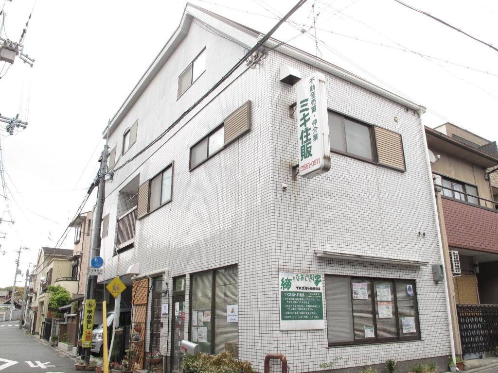 a white building on the corner of a street at Kyoto Inn Higashiyama in Kyoto