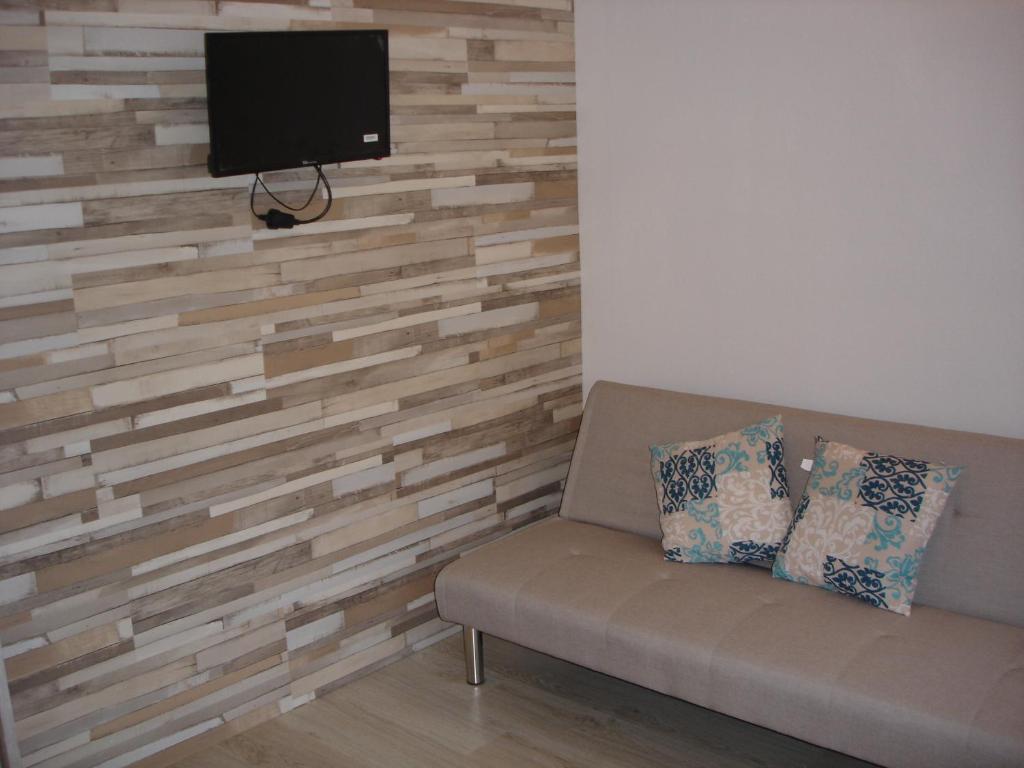 Televízia a/alebo spoločenská miestnosť v ubytovaní Legacy Apartments
