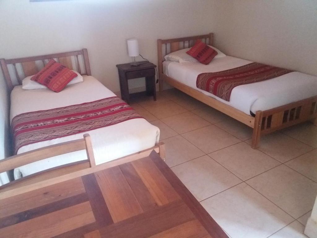 Postel nebo postele na pokoji v ubytování Hostal Nuevo Amanecer