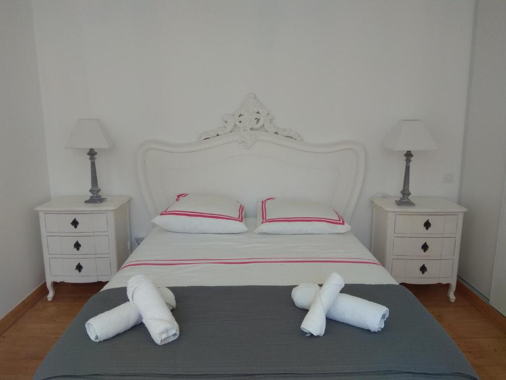 a white bed with two pillows and two night stands at Atelier Liberation in Bourgoin