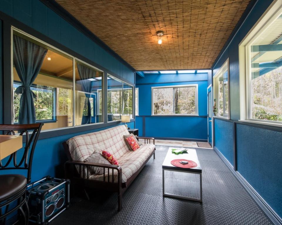 a living room with a couch and a table at Honu Hale in Volcano