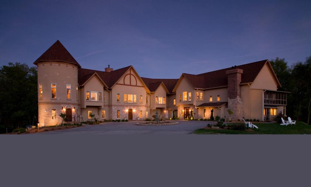 a large house with a turret at night at Goldmoor Inn & Resort in Galena