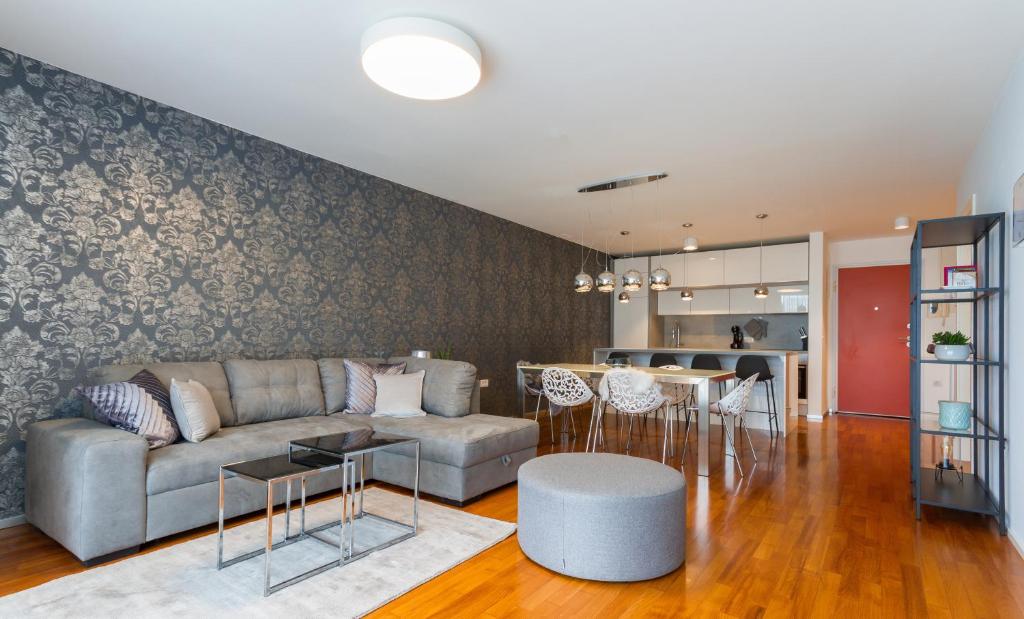 a living room with a couch and a table at Apartments Lux by Locap Group in Portorož