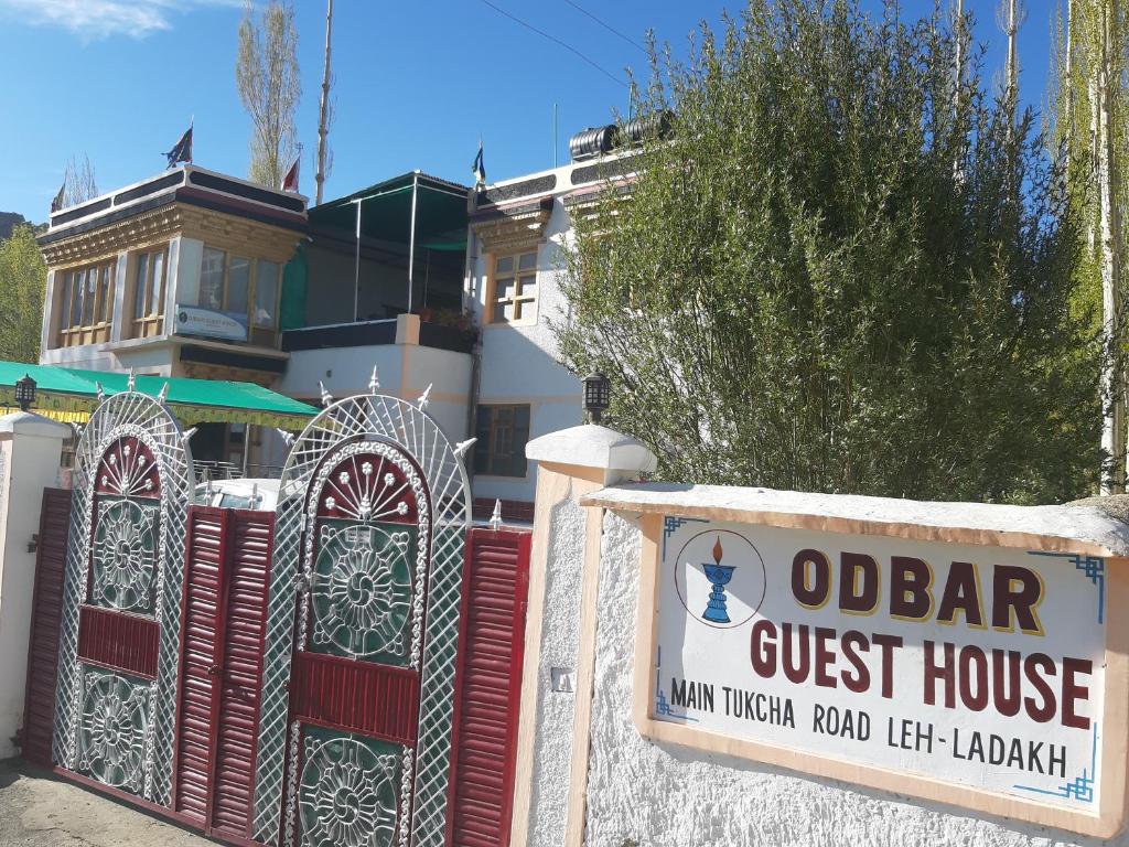 una puerta delante de un hostal con un cartel en Odbar Guest House Best Guest House at Leh Ladakh, en Leh