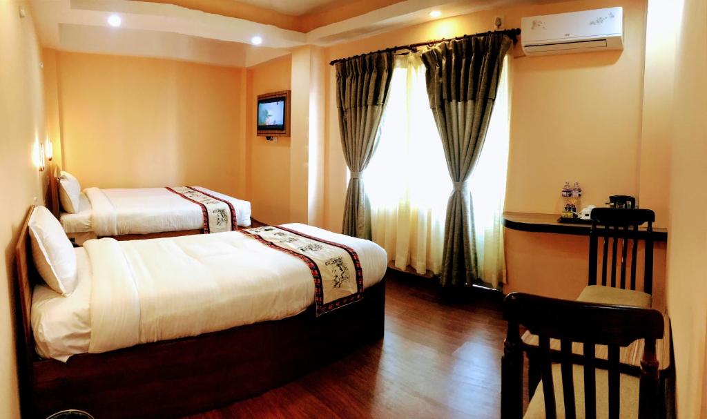 Postel nebo postele na pokoji v ubytování Kathmandu Garden Home