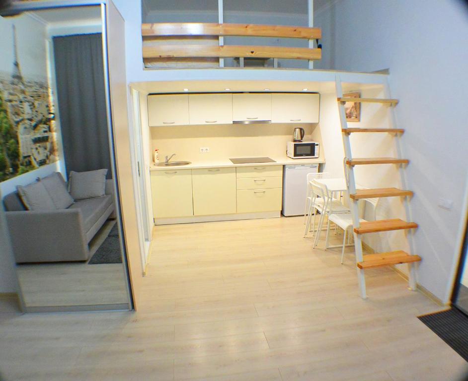 a small apartment with a loft bed and a kitchen at Студия Париж в Александровском саду in Adler