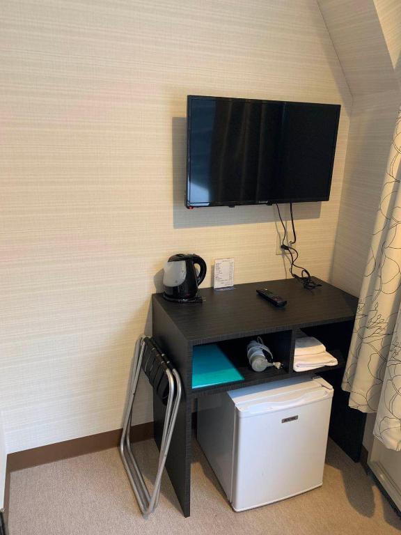 TV a/nebo společenská místnost v ubytování Tabata Oji Hotel