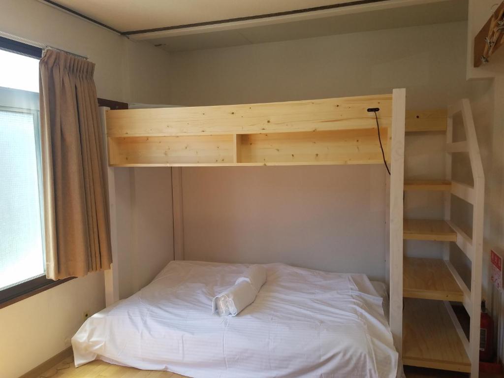 a bedroom with a bunk bed and a ladder at M's Kanazawa in Kanazawa