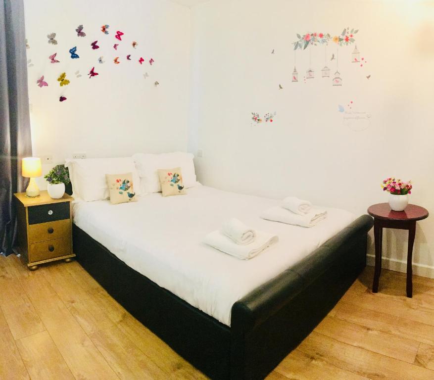 a bedroom with a bed with butterflies on the wall at Private Studio Free Parking in Oxford