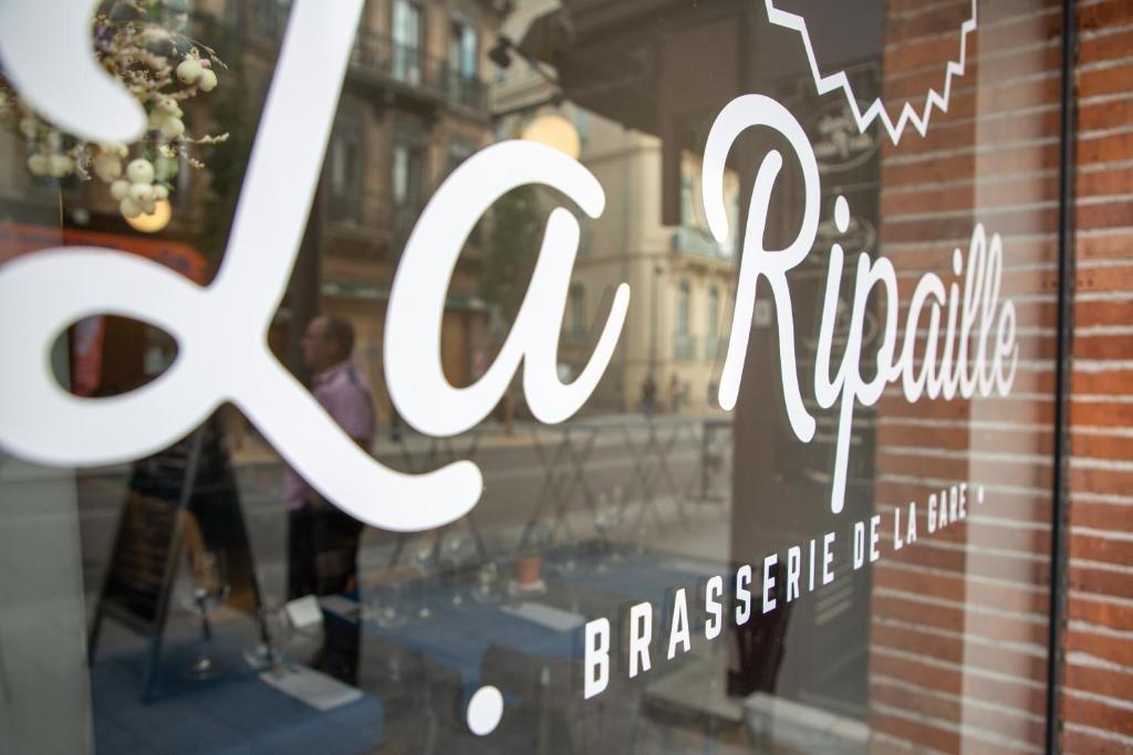 a window of a store with a sign on it at Grand Hôtel d&#39;Orléans in Toulouse