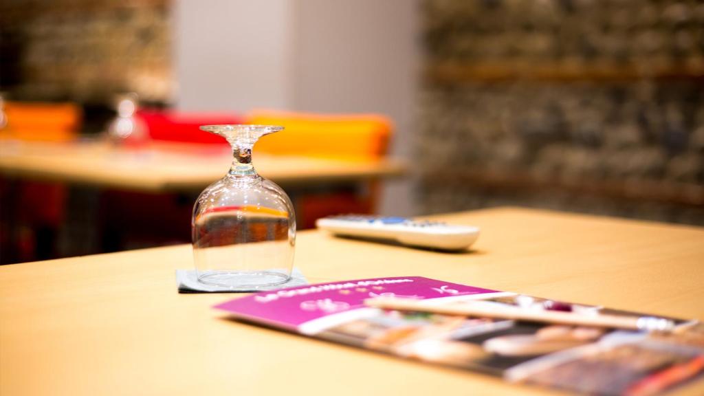 a bottle of water sitting on top of a table at Grand Hôtel d&#39;Orléans in Toulouse