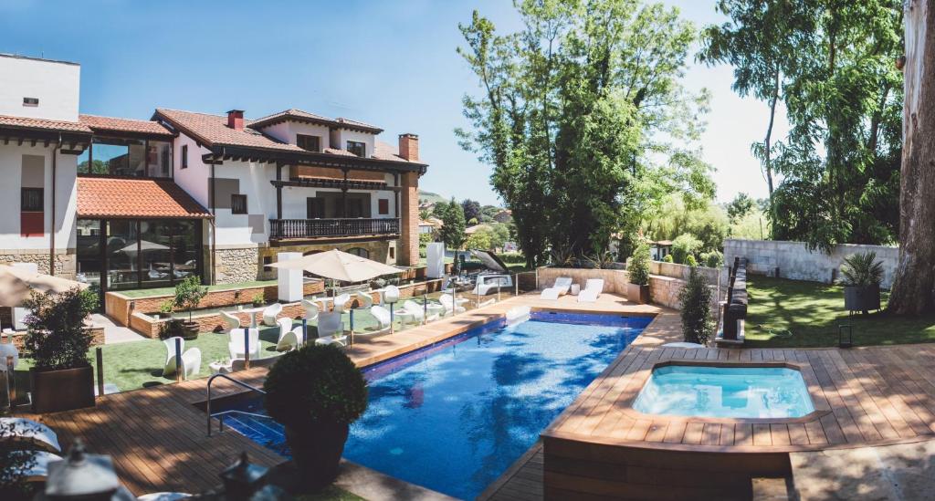 a pool in the backyard of a house at Hotel Cuevas - Adults Only in Santillana del Mar