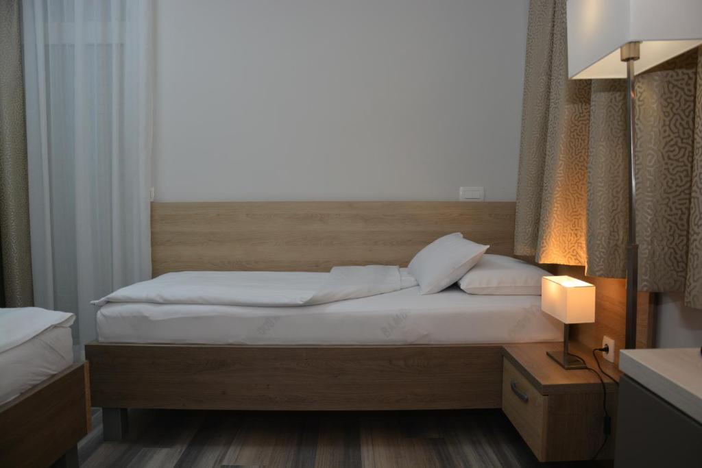 a bedroom with a bed and a window at Hotel Fiesa in Piran
