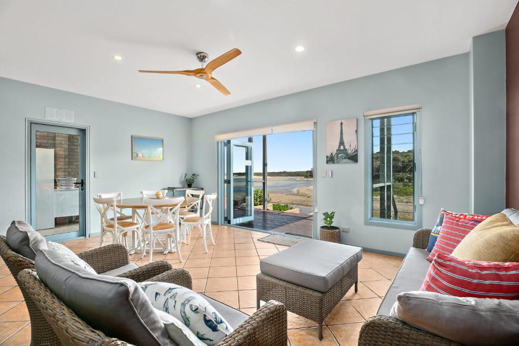 a living room with a couch and chairs and a table at Nosie 1 in Sawtell