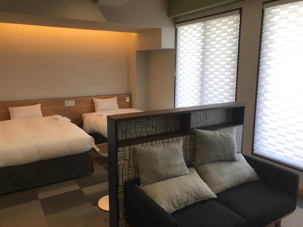 Postel nebo postele na pokoji v ubytování Hotel Yururito Osaka