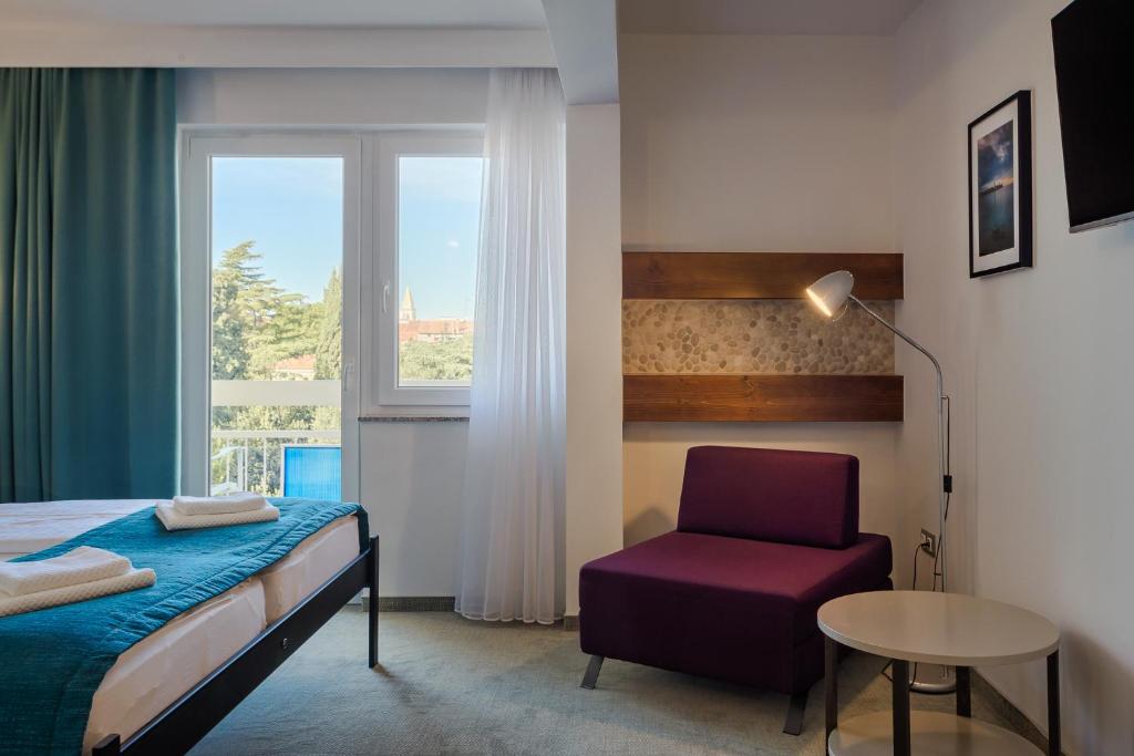 Postel nebo postele na pokoji v ubytování Hotel Porec