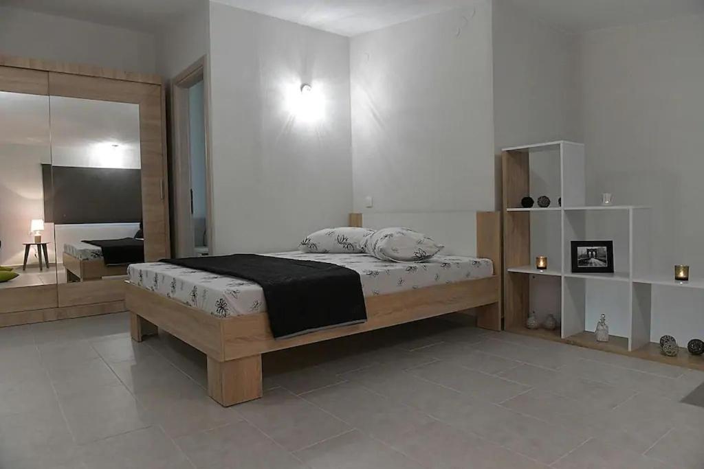 a bedroom with a bed and a large mirror at Crystallia SeaSide Maisonette by RentalsPro- Nea Moudania in Nea Moudania