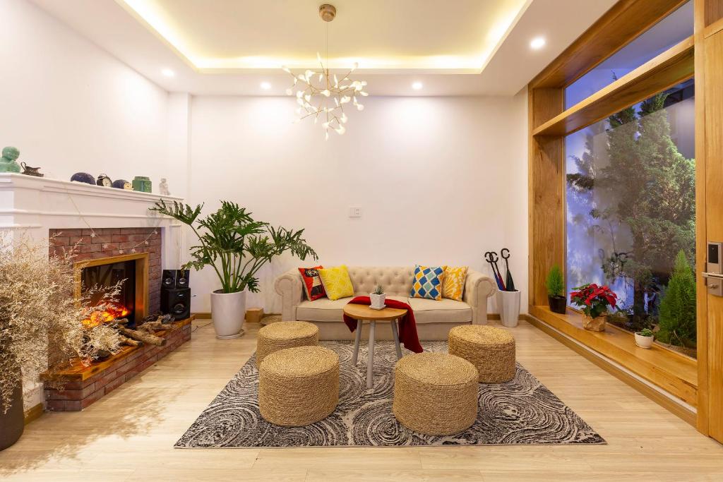 a living room with a couch and a fireplace at MayMay Da Lat Apartments in Da Lat