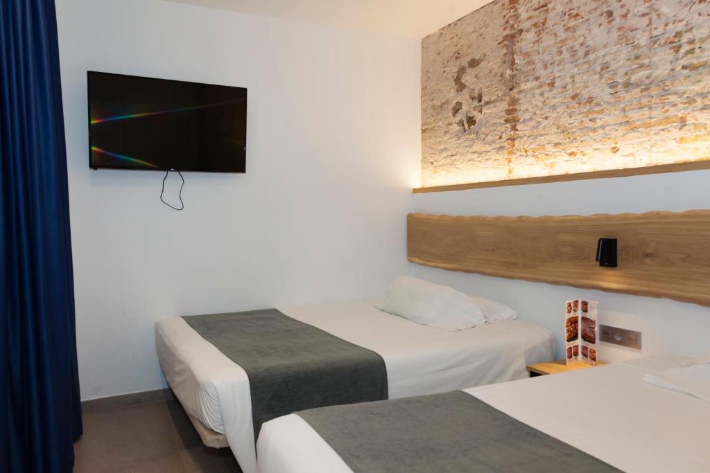 Postel nebo postele na pokoji v ubytování Hostal Paris