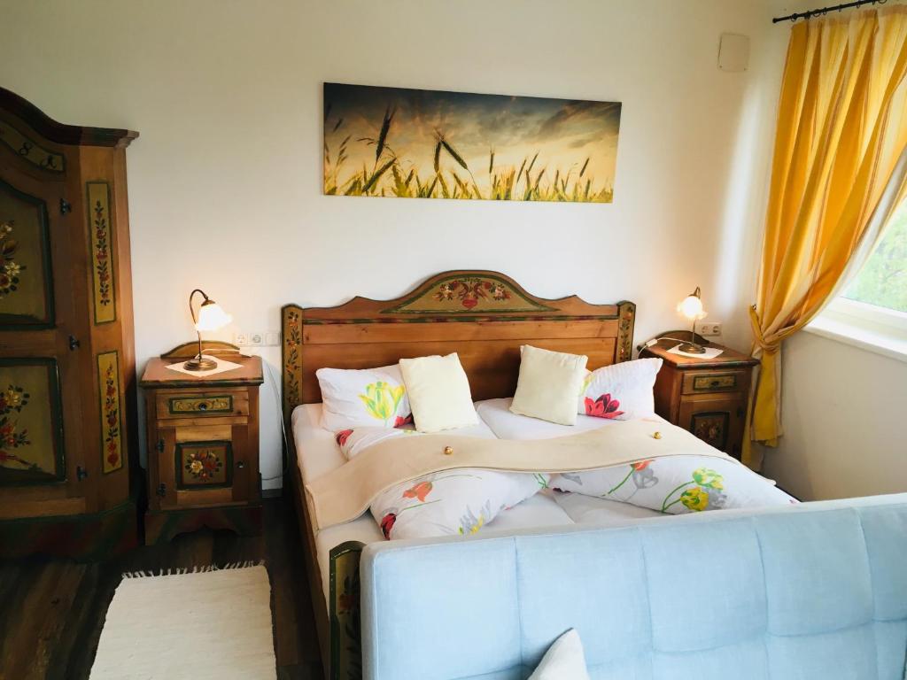 a bedroom with two beds and two night stands at Pension Marillenhof in Melk