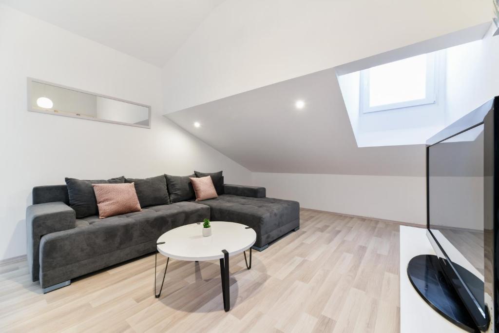 a living room with a couch and a table at GREY Apartment Old Town in Zadar